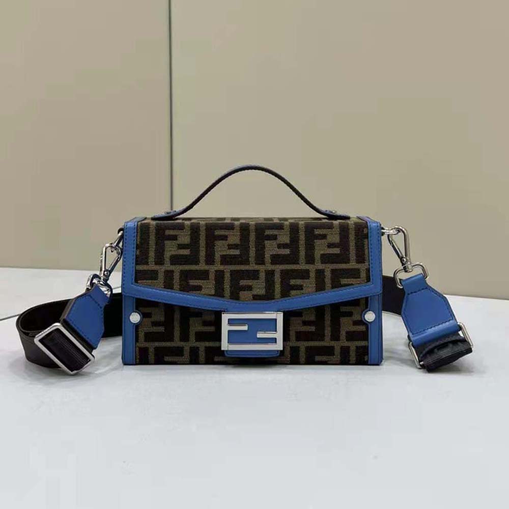 Close-up of gold-tone hardware on Fendi Men Soft Trunk Baguette Blue Leather and FF Fabric Bag