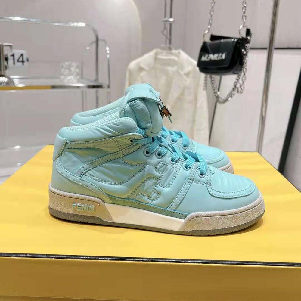 Close-up on lace and Fendi logo hardware of the turquoise high-tops