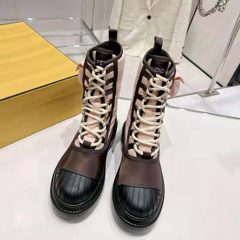 Close-up on silver Fendi hardware on pink nylon boot tongue