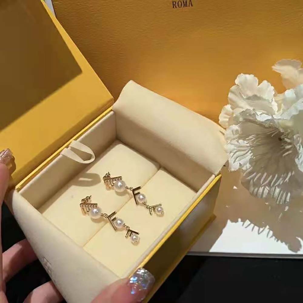 Side profile of gold-colored Fendi Women First Earrings with post closure