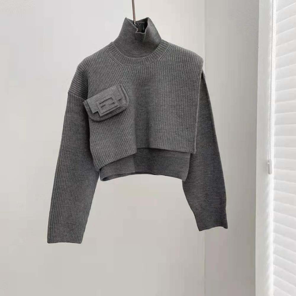Close-up detail of ribbed cuff and Fendi logo on gray sweater