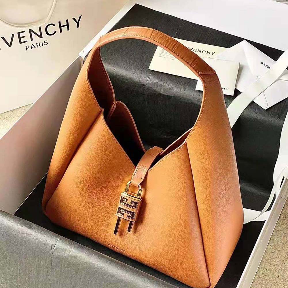 Close-up of gold-tone signature G hardware on Givenchy brown hobo bag