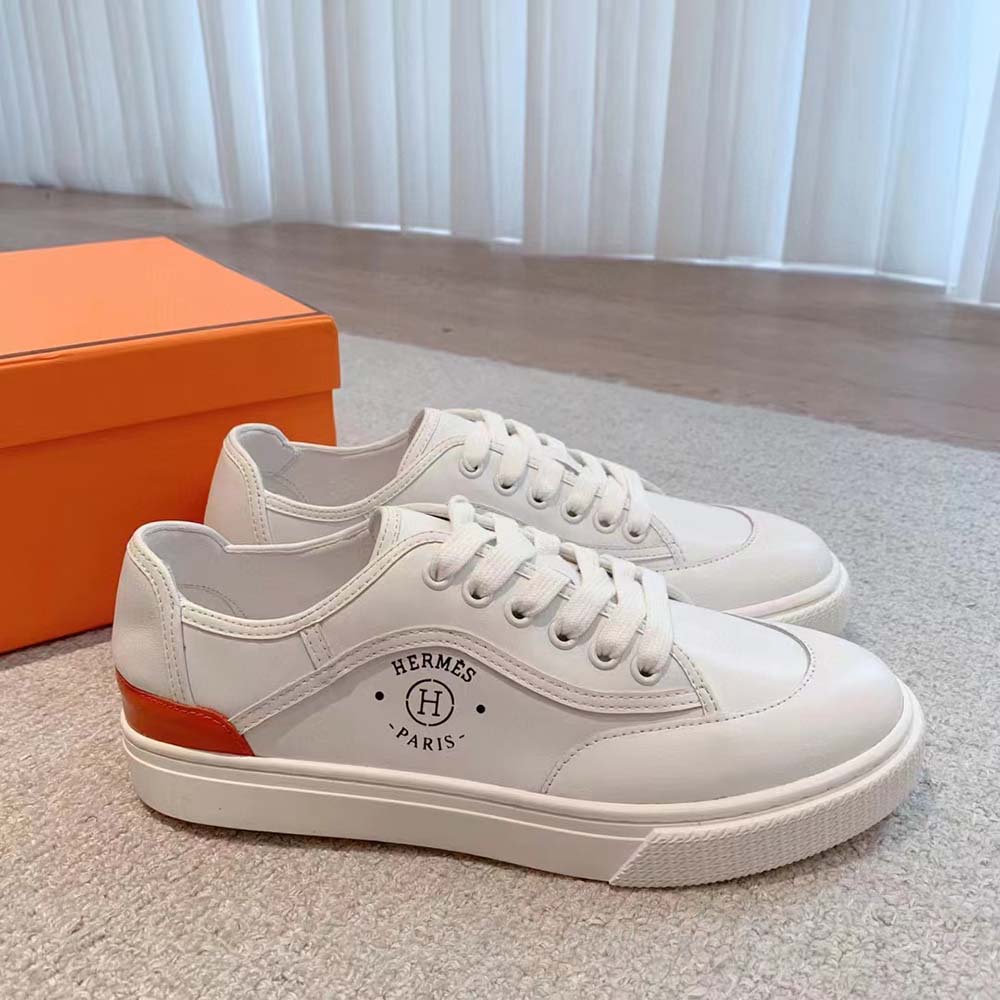 Close-up of signature “Hermès Paris” stencil on white Get Sneaker