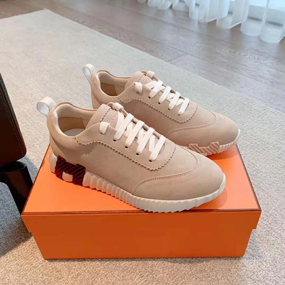 Close-up of suede texture and embossed logo on Hermes Women Bouncing Sneaker