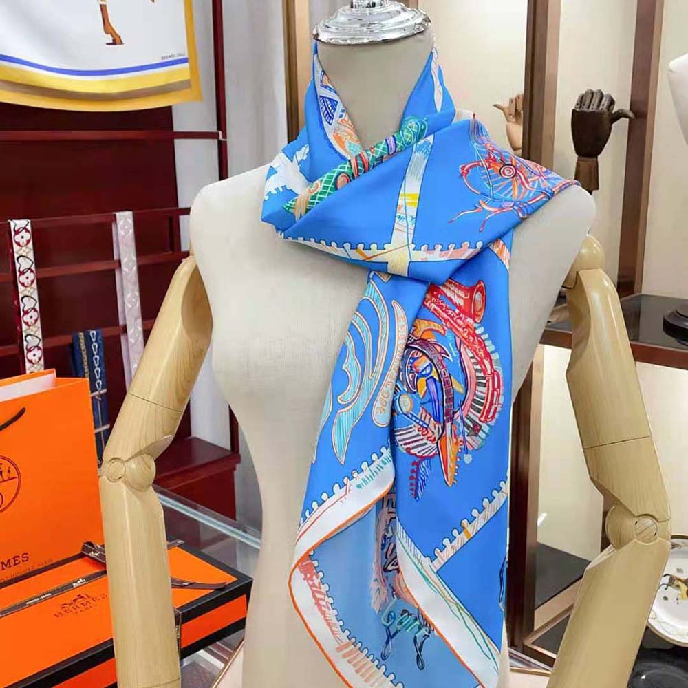 Hermes Women Chevaloscope Scarf 90 folded showing vibrant blue design