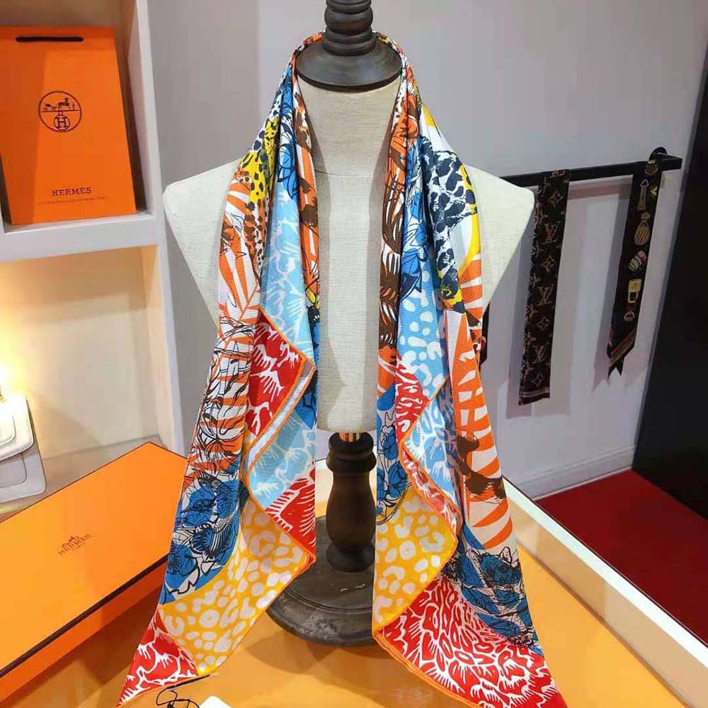Model wearing orange Hermes Women Jungle Love Stamped Scarf 70 styled neckwrap
