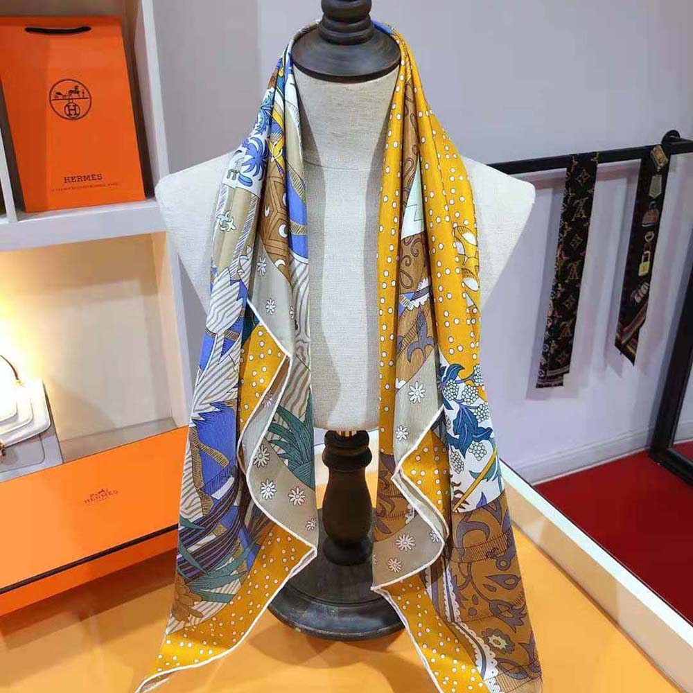 Full view of Hermes Women Le Premier Chant Scarf 90 vibrant yellow folded on white background