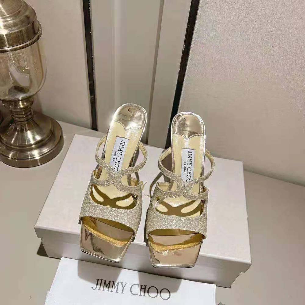 Close-up of gold glitter fabric and platinum hardware on Jimmy Choo Anise mules