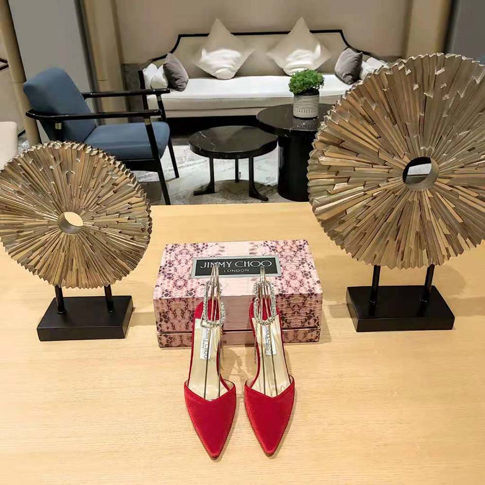 Close-up on crystal embellishments on Jimmy Choo Saeda 85 red velvet pumps