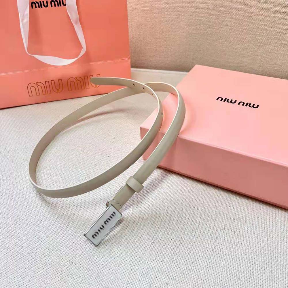 Side angle showing brushed leather texture on Miu Miu white belt