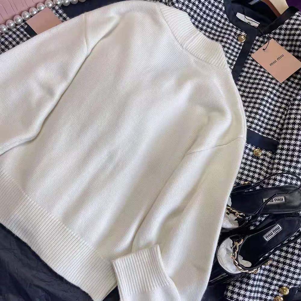 Side profile showing slim fit silhouette of Miu Miu cashmere cardigan white