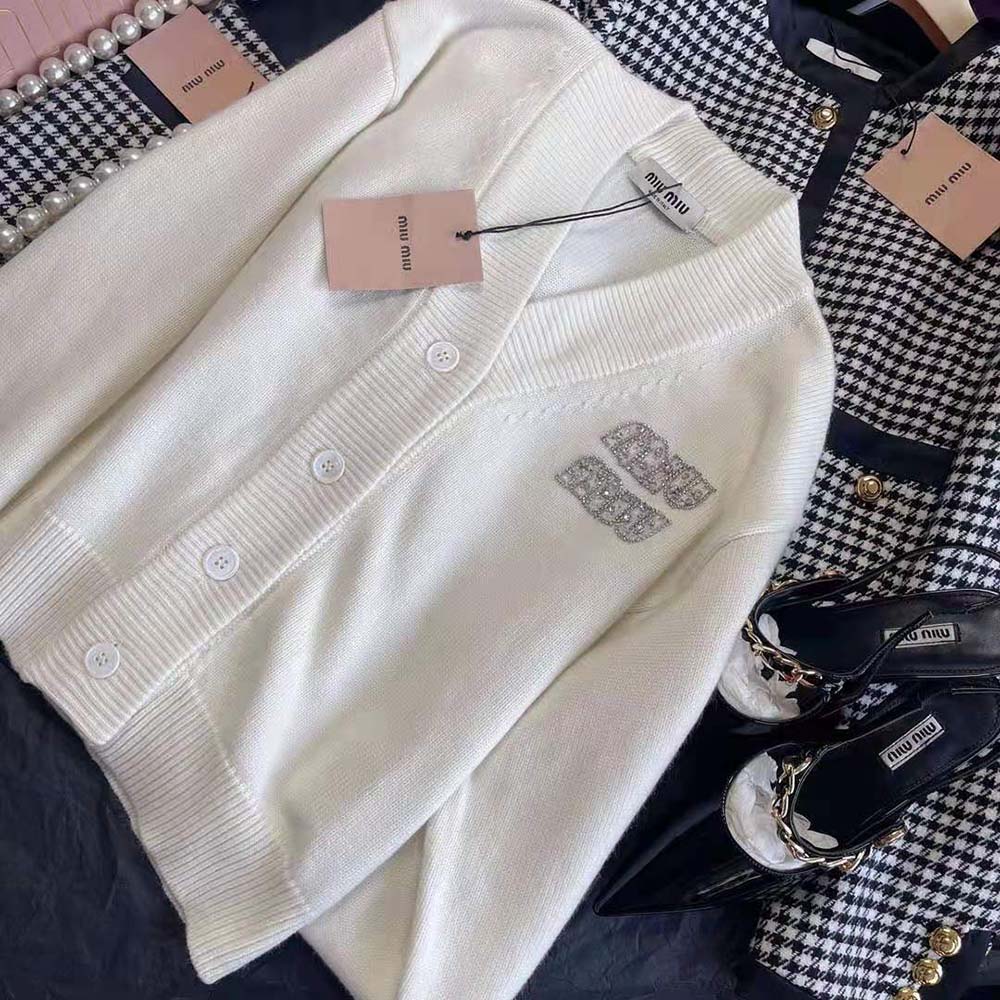 Close-up detail of embroidered logo on Miu Miu cashmere cardigan white