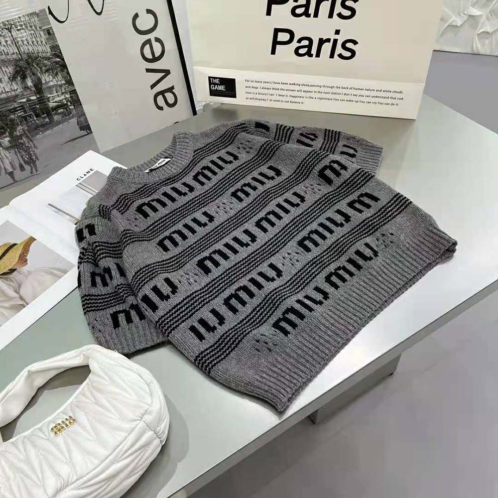 Close-up of intarsia knit logo detail on Miu Miu cashmere sweater