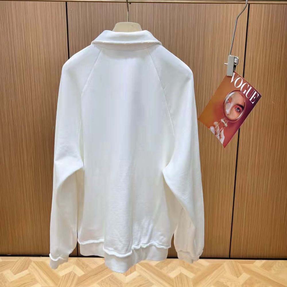 Side profile showing ribbed collar and cuff on Miu Miu polo sweatshirt