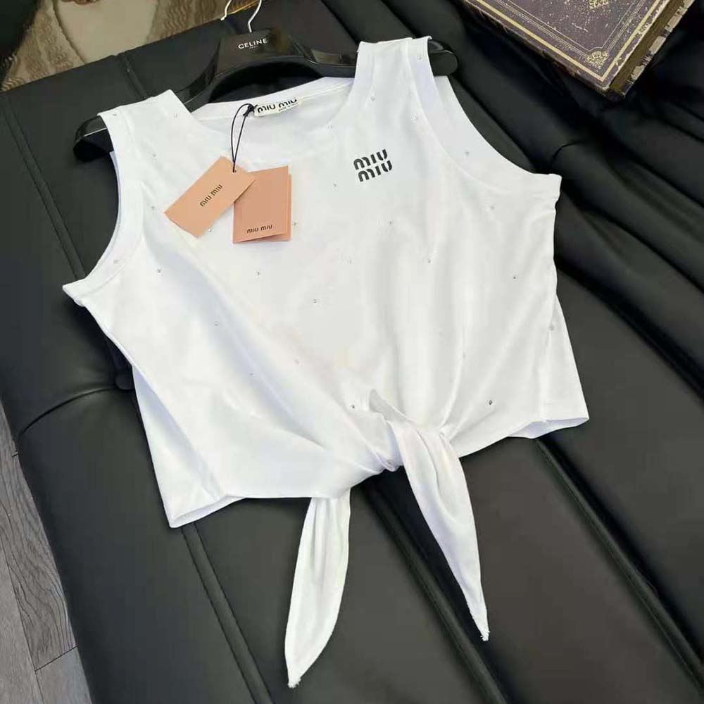 Side angle showing embroidered logo detail on white Miu Miu cotton top