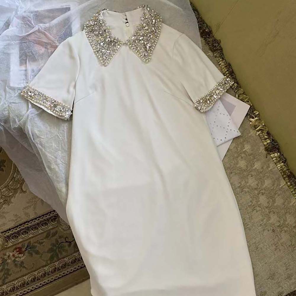 Side profile of Miu Miu Women Crystal-Embellished Shift Dress-White with smooth silhouette