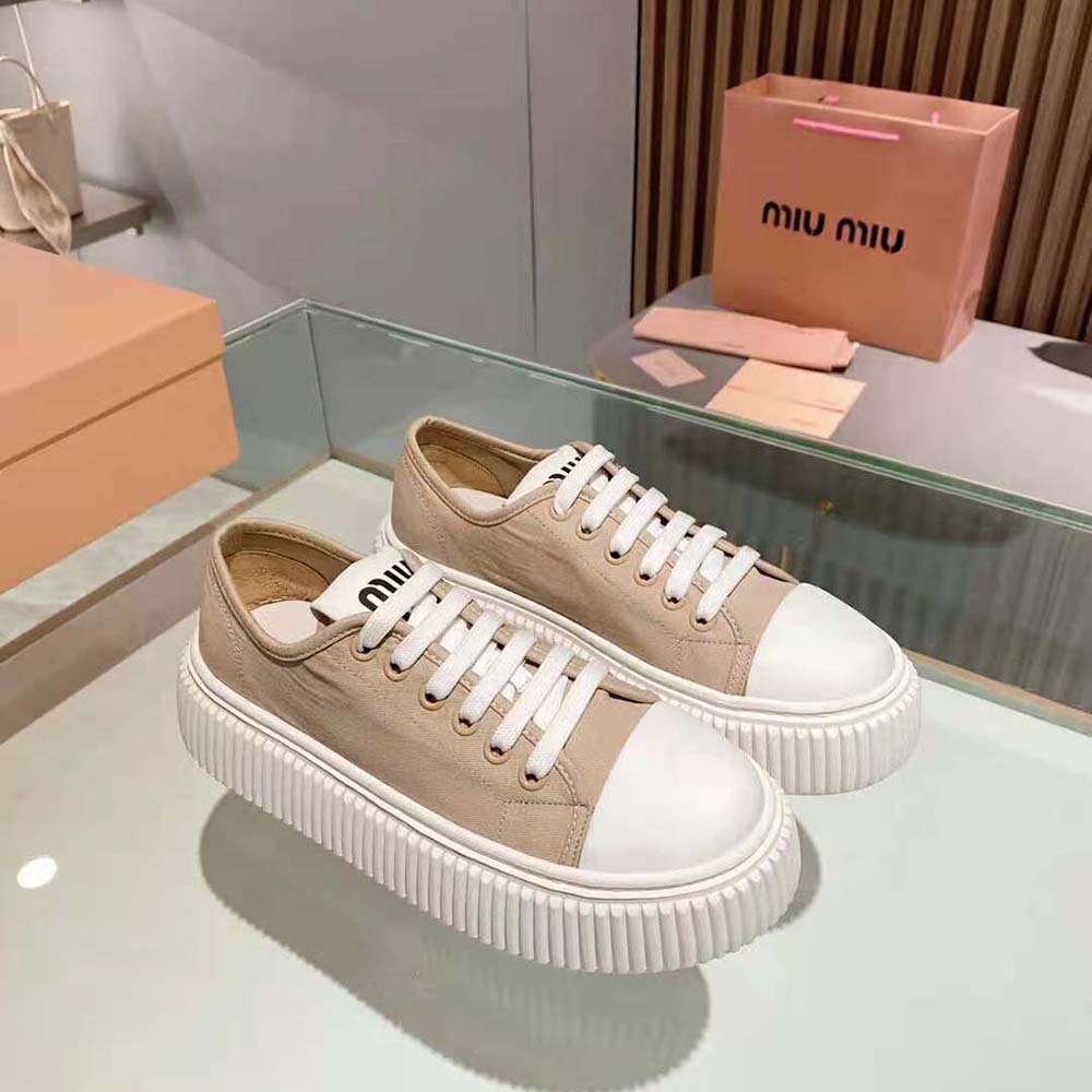Close-up of embroidered logo on pink denim Miu Miu sneakers