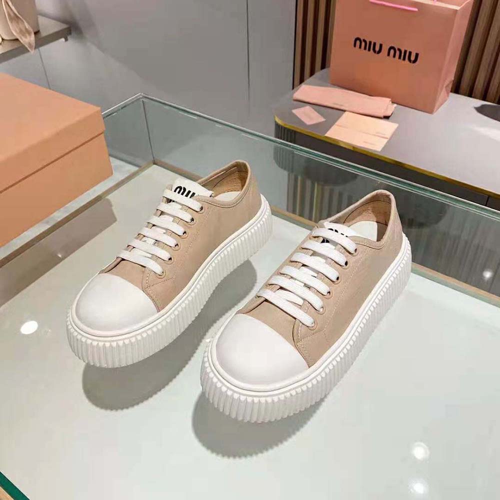 Top view showcasing lace-up closure on pink denim Miu Miu sneakers