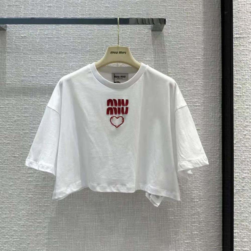 Close-up of embroidered contrasting logo on white Miu Miu T-shirt