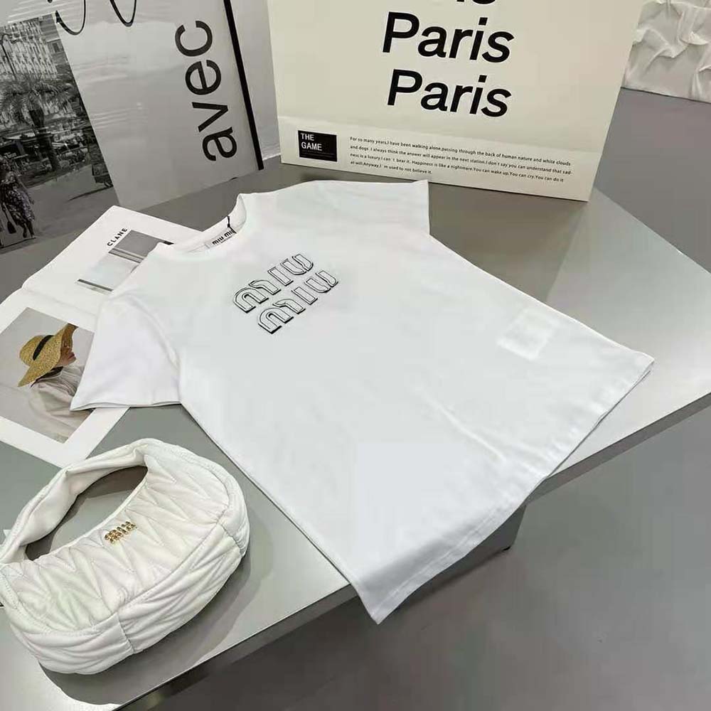 Close-up on embroidered Miu Miu logo on white cotton T-shirt