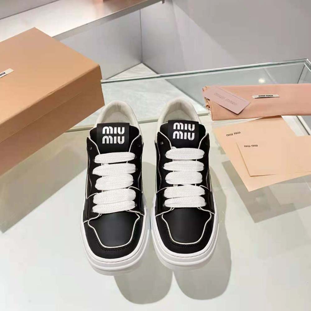 Close-up of black leather and silver hardware on Miu Miu sneakers