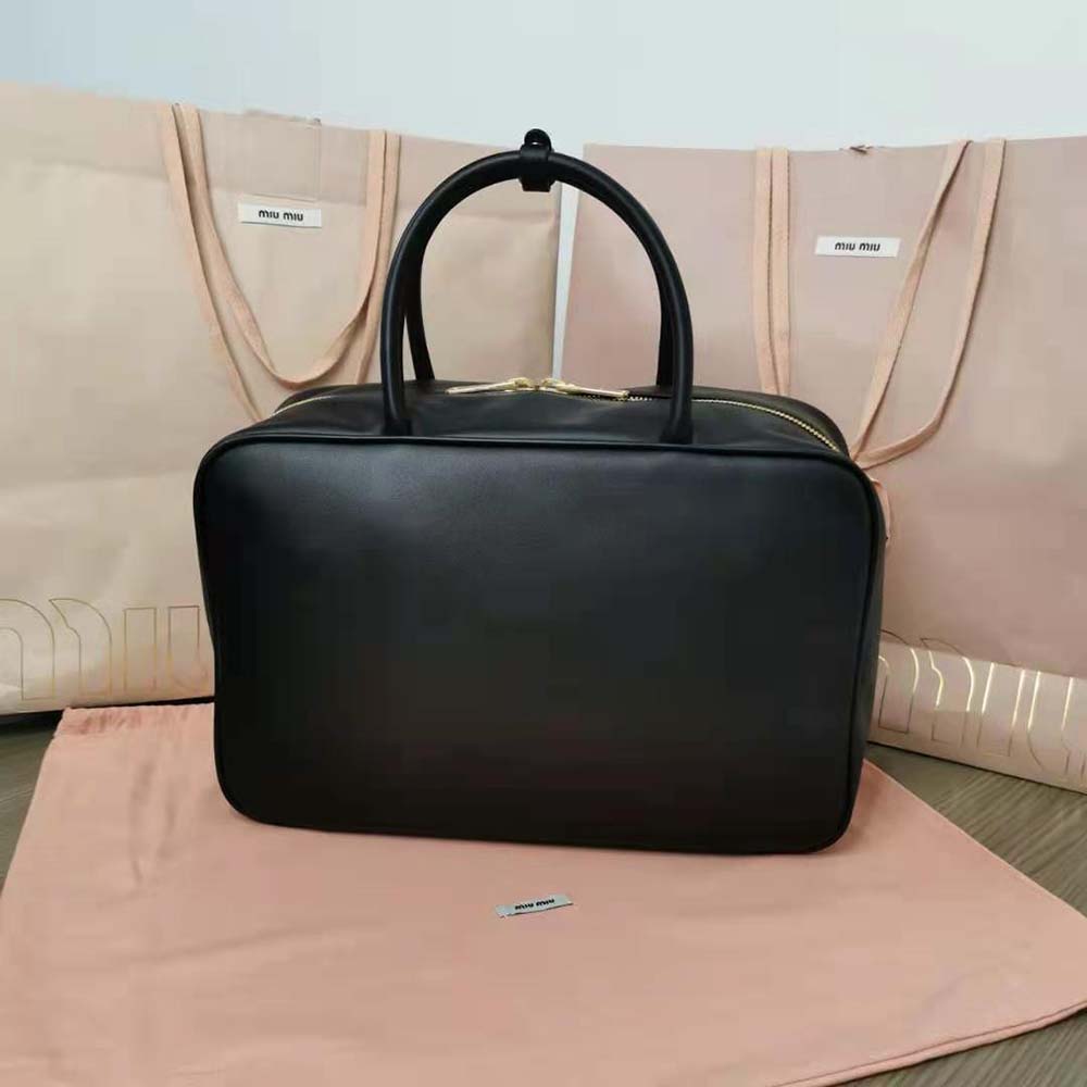 Side angle of Miu Miu Women Leather Top-Handle Bag-Black highlighting leather texture
