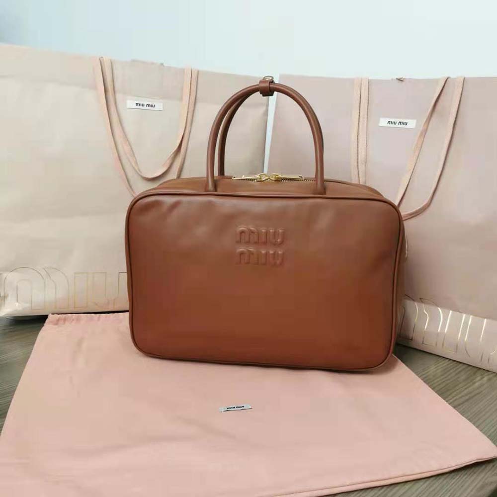 Close-up of gold-tone hardware on Miu Miu Women Leather Top-Handle Bag-Brown