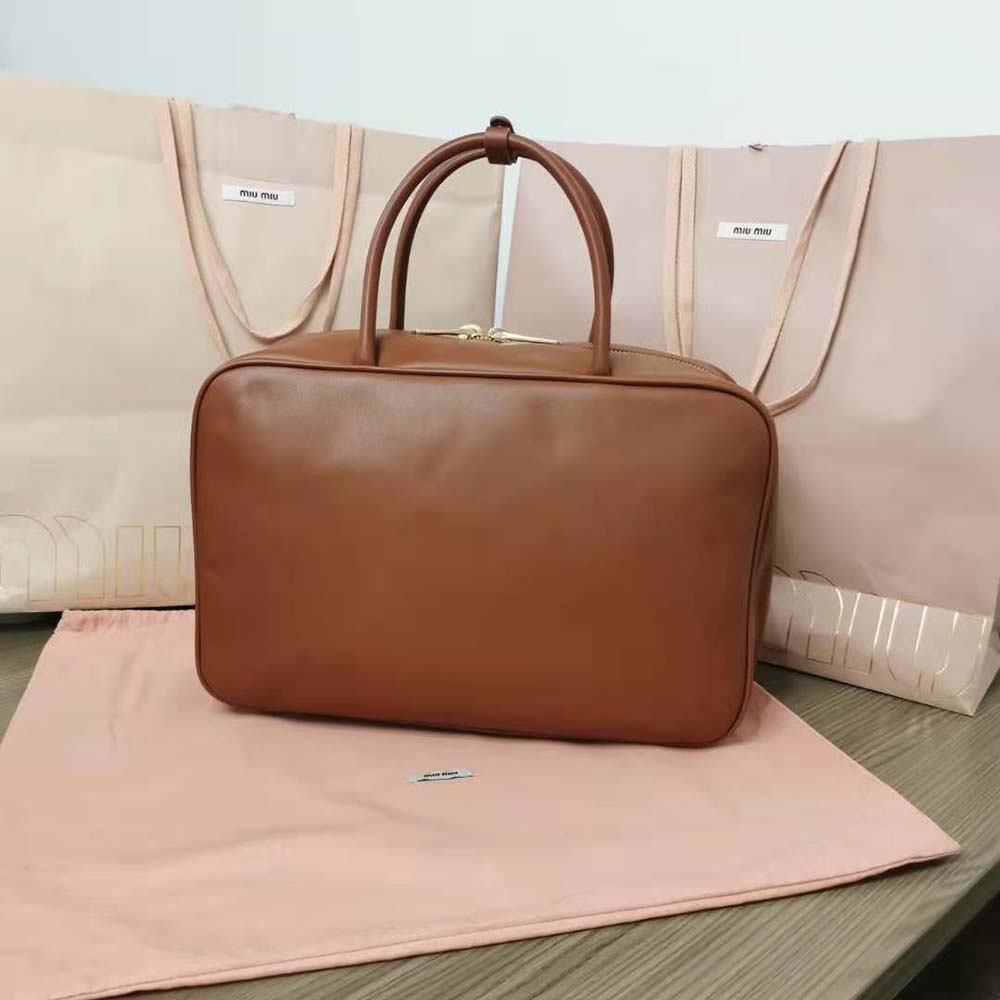 Side angle of Miu Miu Women Leather Top-Handle Bag-Brown capturing texture
