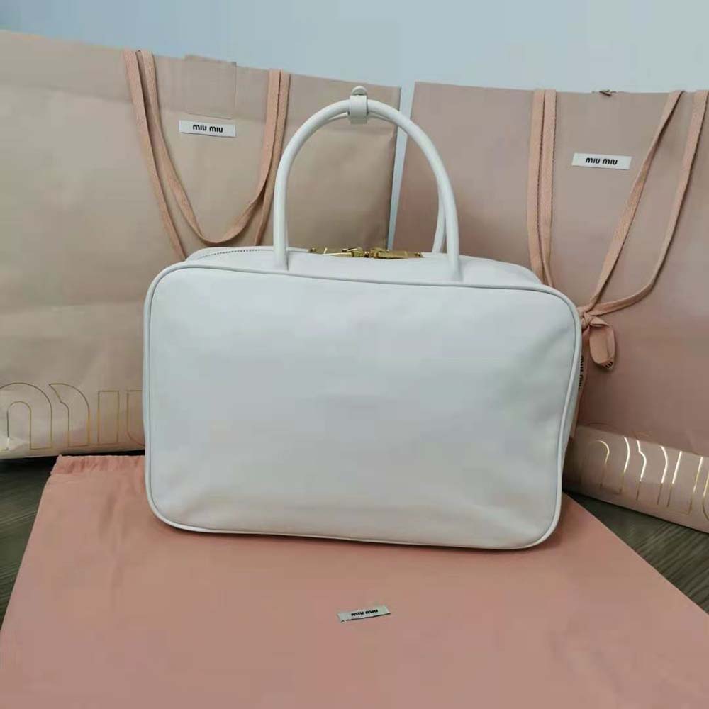 Side angle showing structured silhouette of Miu Miu Women Leather Top-Handle Bag-White