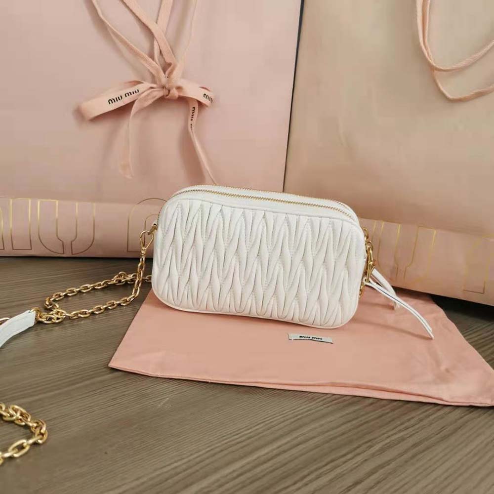 Side angle showing compact silhouette of Miu Miu Women Matelassé Nappa Leather Mini-Bag-White