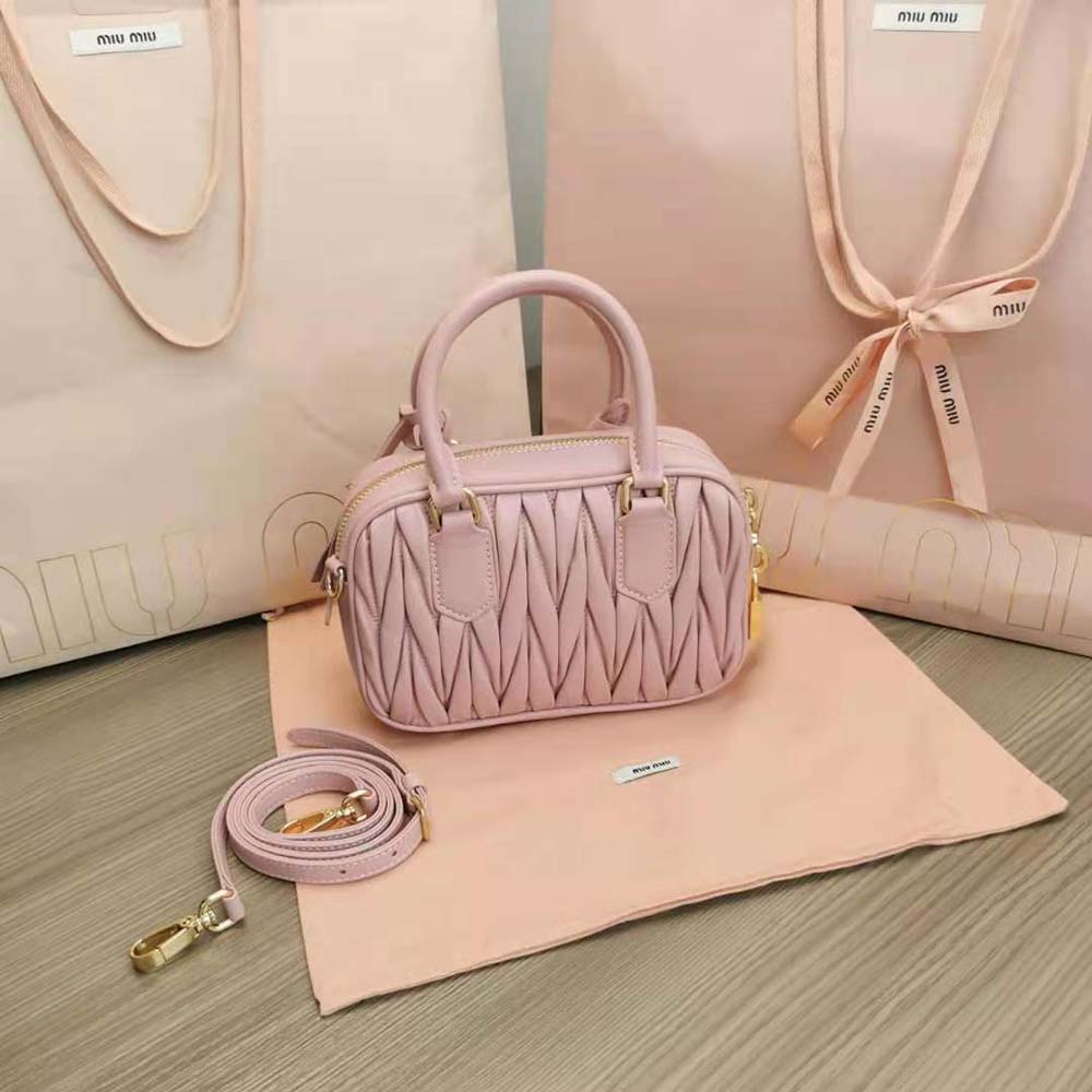 Side angle showing silver hardware on Miu Miu leather handbag