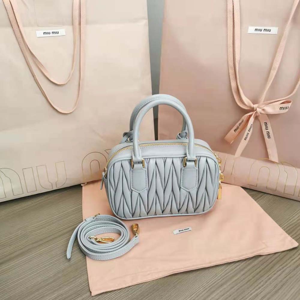 Side angle showing compact silhouette of Miu Miu Women Matelassé Nappa Leather Top-Handle Bag-Silver