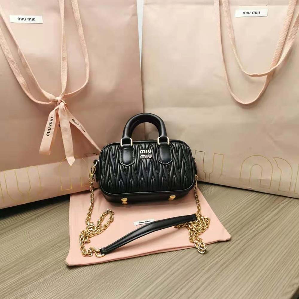 Close-up of quilted matelassé texture on Miu Miu mini-bag in black