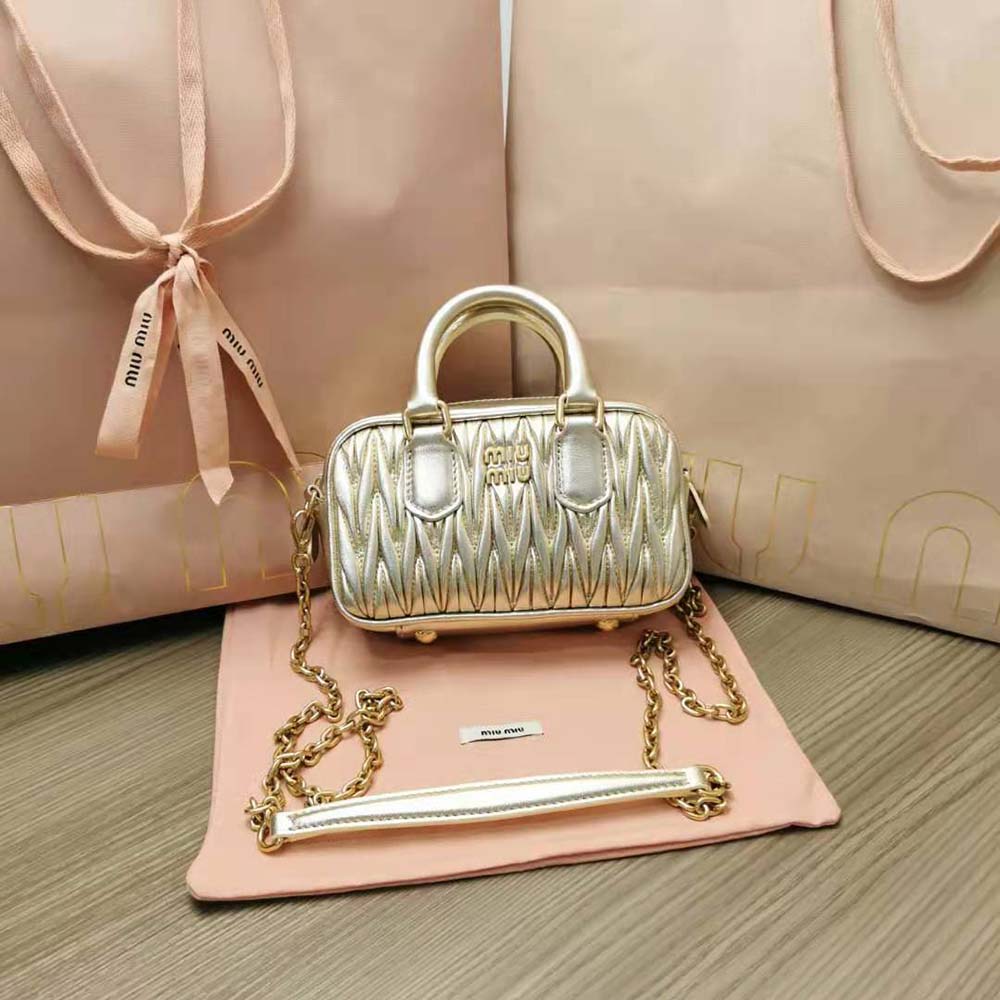 Close-up of gold-tone hardware and matelassé quilting detail on Miu Miu mini-bag