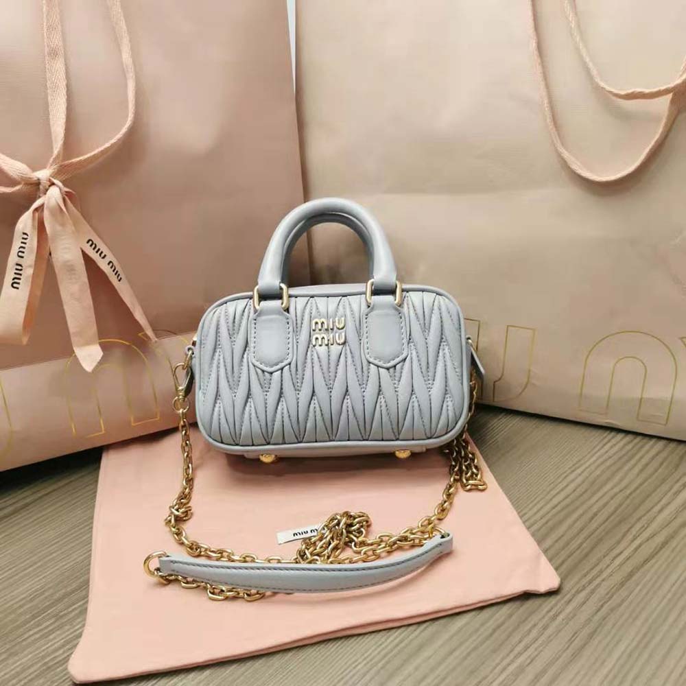 Close-up of quilted matelassé texture on Miu Miu silver mini-bag
