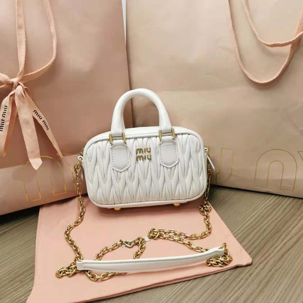 Close-up detail of matelassé quilting on Miu Miu white mini-bag