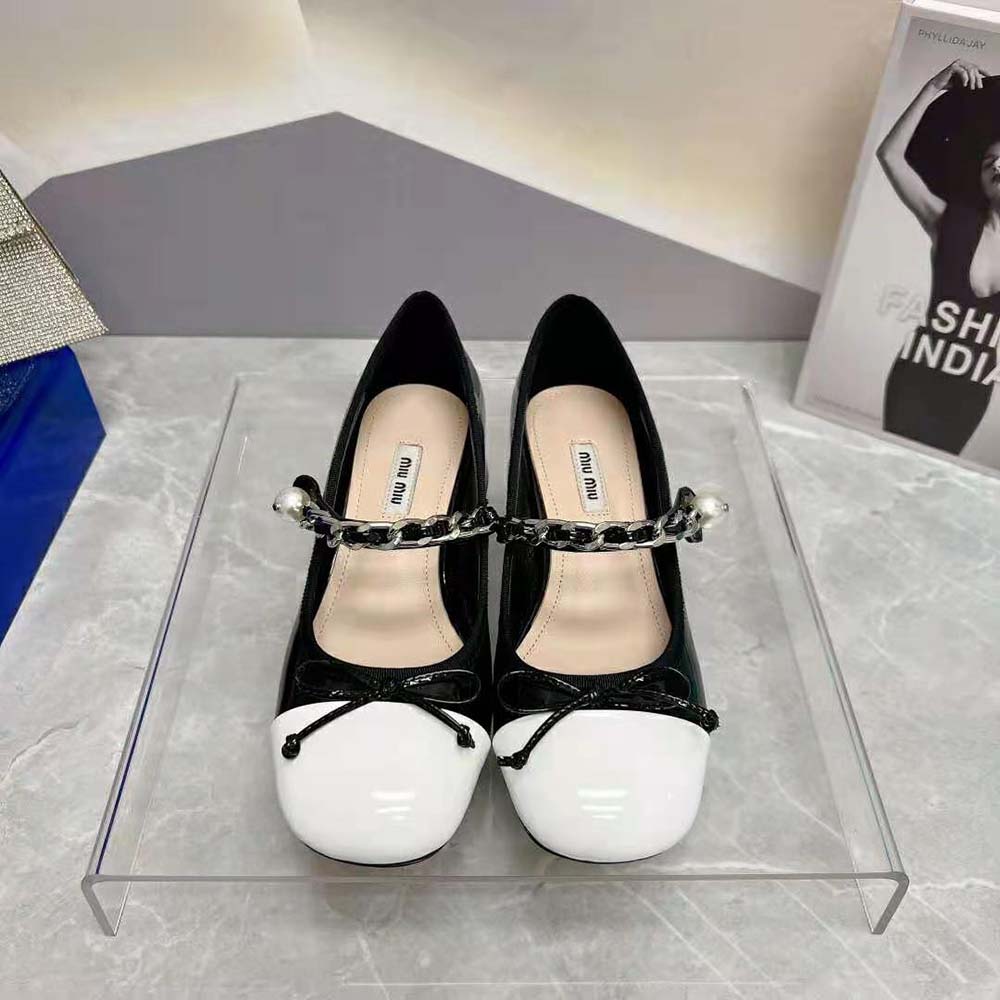 Close-up detail of glossy patent leather on Miu Miu Naplak Pumps