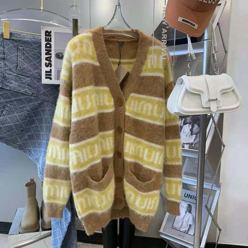 Close-up of intarsia logo detail on yellow Miu Miu mohair cardigan