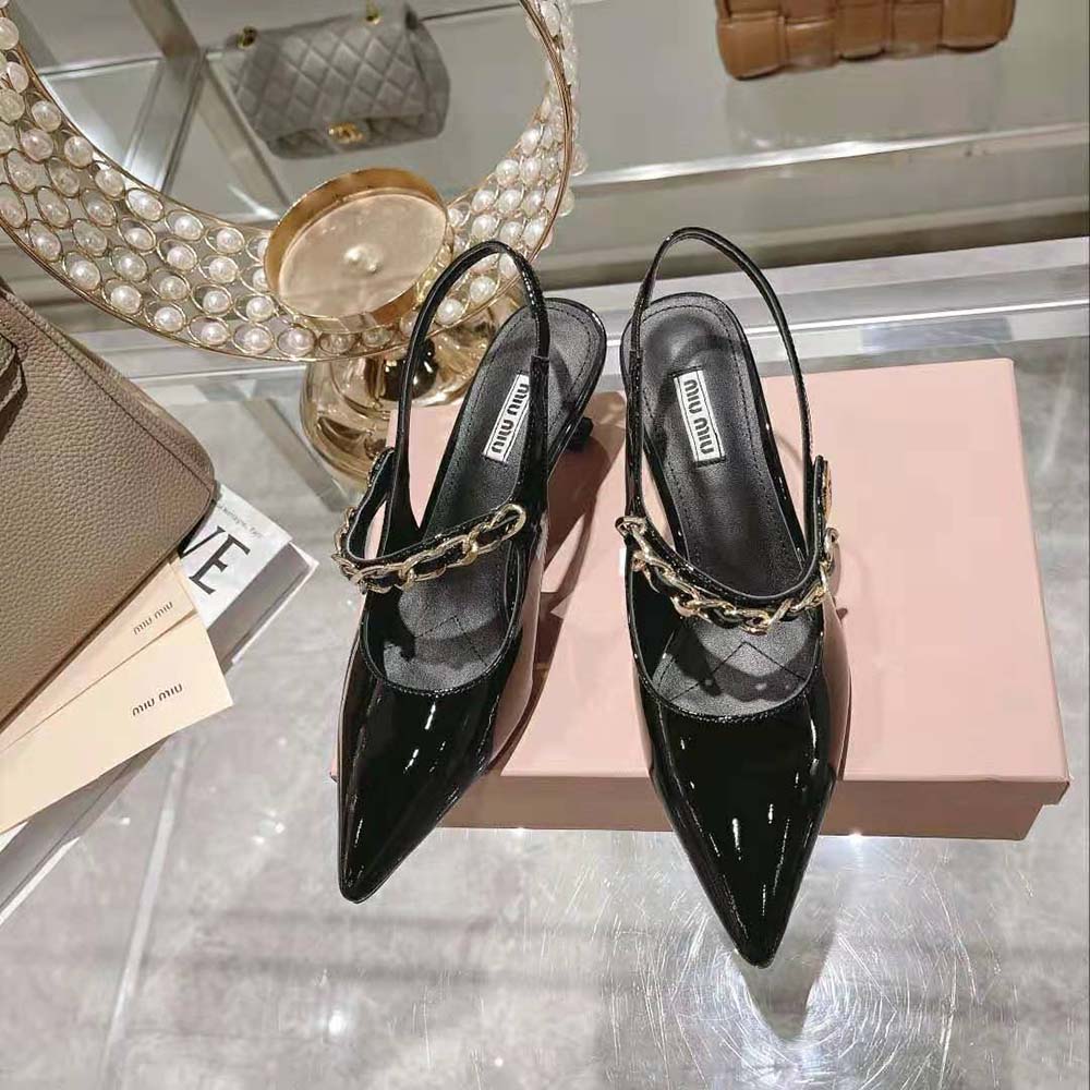 Close-up detail of slingback strap and 55mm heel on Miu Miu patent pumps