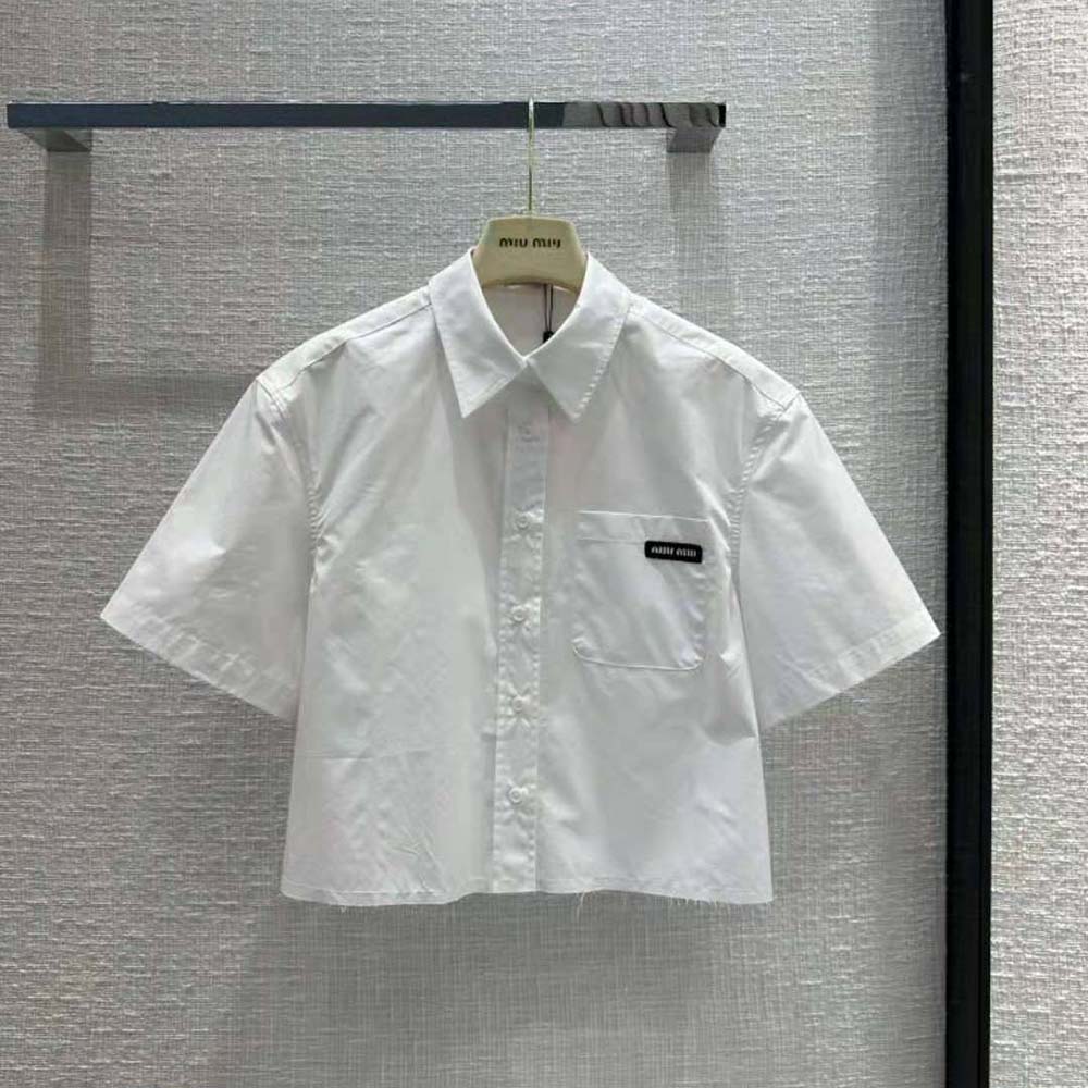 Close-up on sartorial logo label detail on white Miu Miu shirt