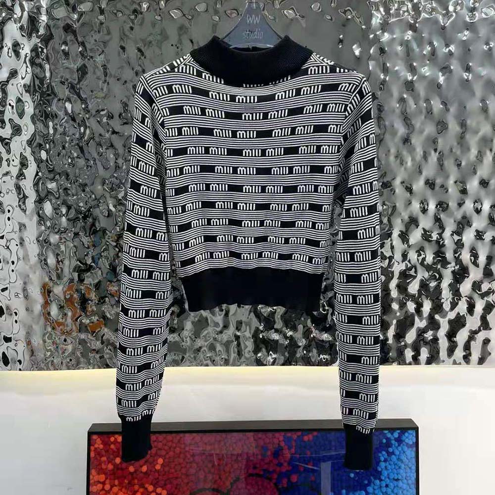 Side angle showing fit of Miu Miu Viscose Turtleneck Cardigan in black
