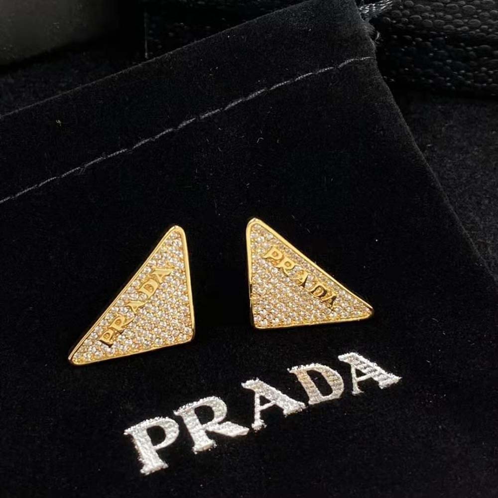 Close-up of crystal Prada logo detail on earrings
