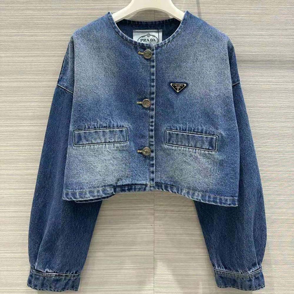 Close-up of enameled metal triangle logo on Prada denim jacket