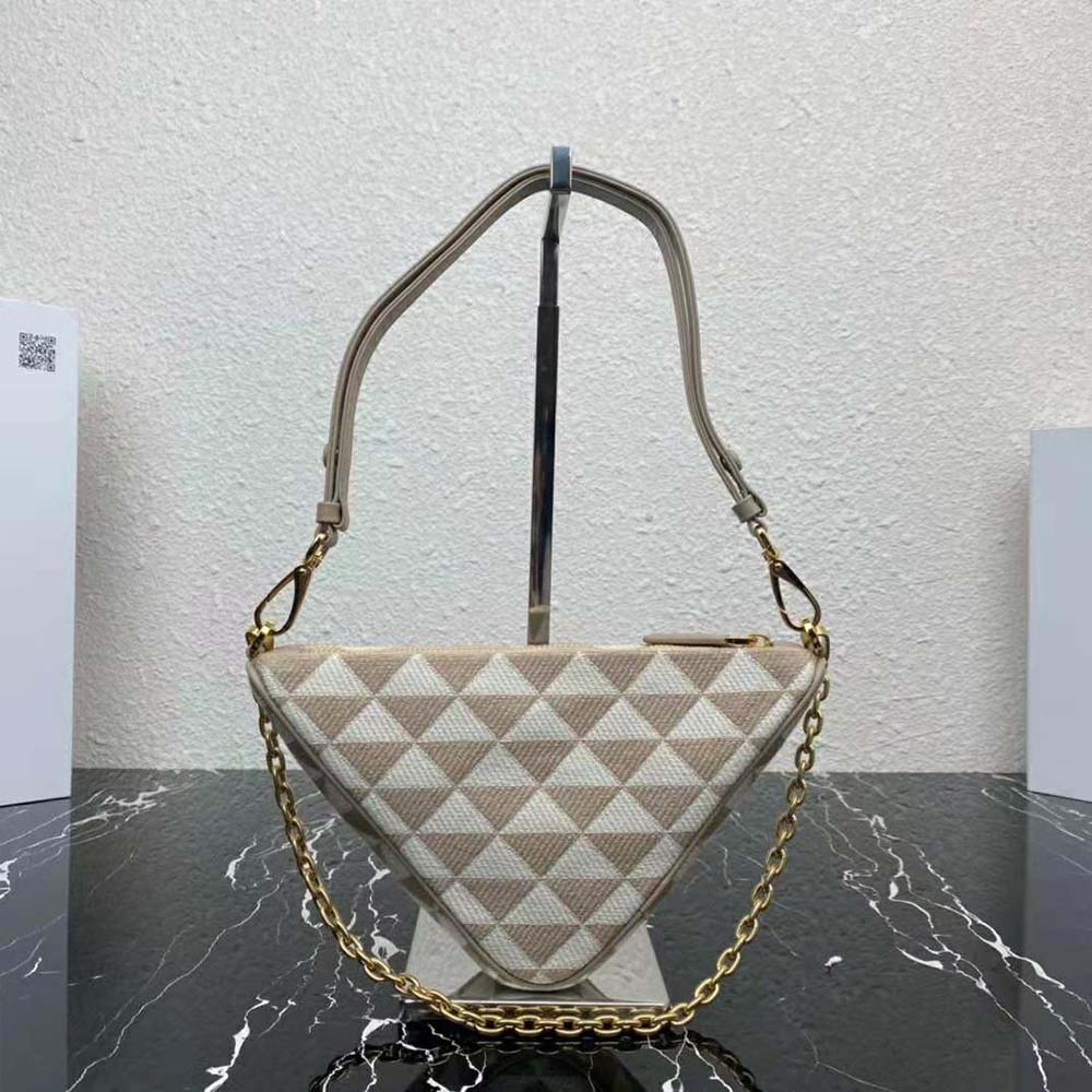 Side angle showing compact silhouette and flap closure of Prada mini-bag beige