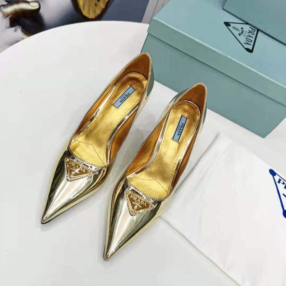 Close-up of gold metallic leather and signature Prada detail on pump