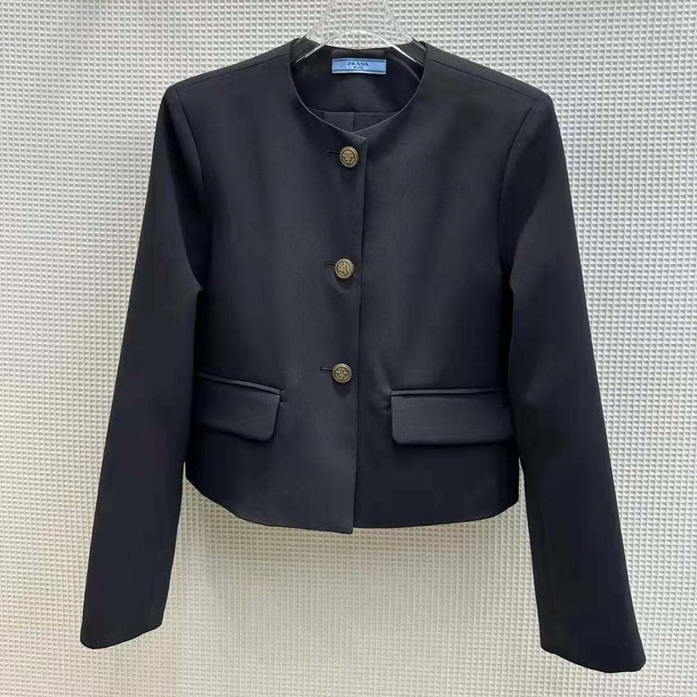 Close-up of Prada jacket’s branded buttons and tricotine fabric texture