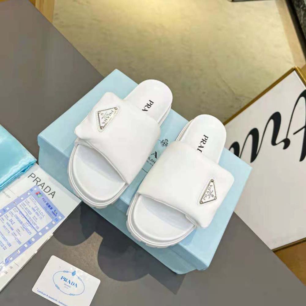 Close-up of padded nappa leather and embossed logo on Prada slides
