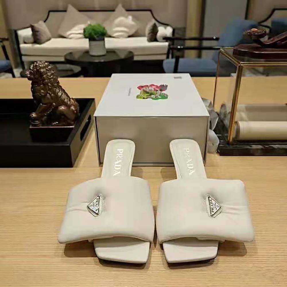 Close-up of padded nappa leather and Prada logo on white sandals