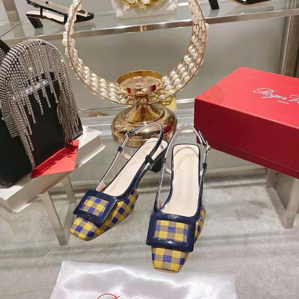 Close-up of glossy yellow fabric and oversized buckle on Roger Vivier Belle Vivier slingbacks