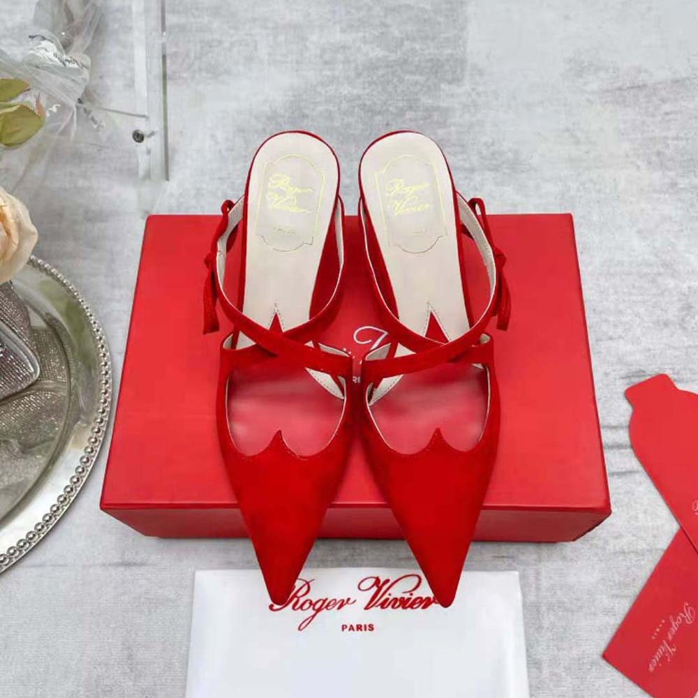 Close-up of oversized bow detail on Roger Vivier red suede mules